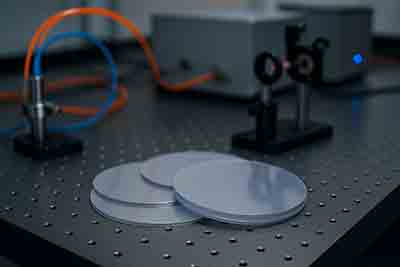 Lithium niobate wafers and periodically poled LiNbO3 device demonstrating nonlinear optical frequency conversion on an optical table